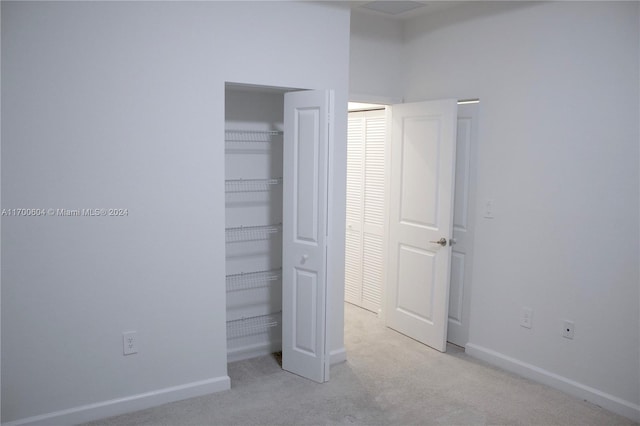 unfurnished bedroom featuring light colored carpet