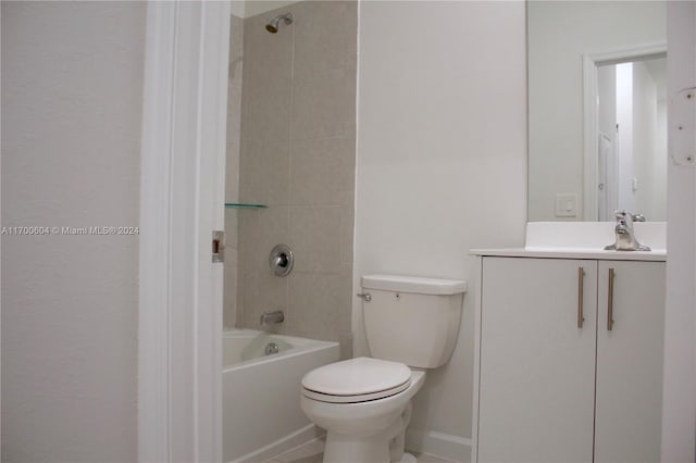 full bathroom featuring toilet, vanity, and tiled shower / bath