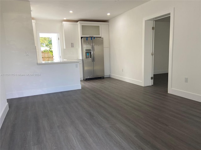 unfurnished living room featuring dark hardwood / wood-style floors