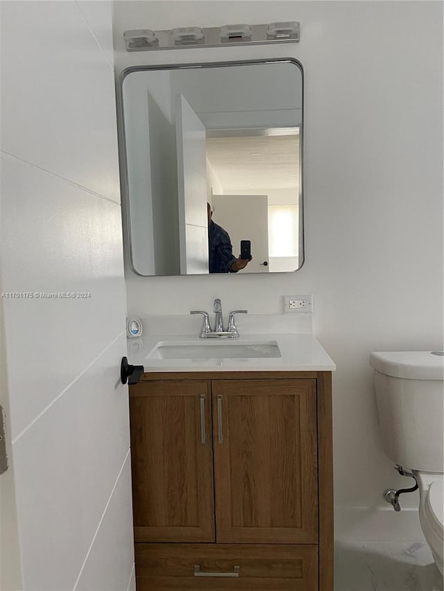 bathroom featuring vanity and toilet