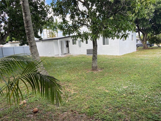 view of yard with central AC unit and french doors