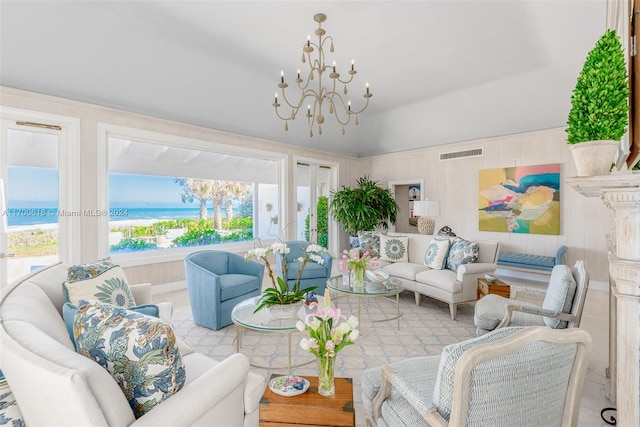 living room with a water view and a chandelier