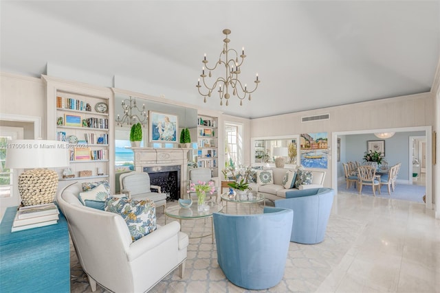 living room featuring plenty of natural light, a chandelier, and vaulted ceiling