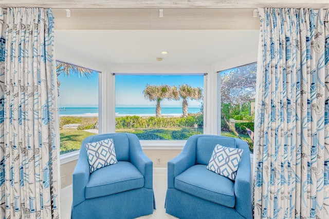 sitting room featuring a water view