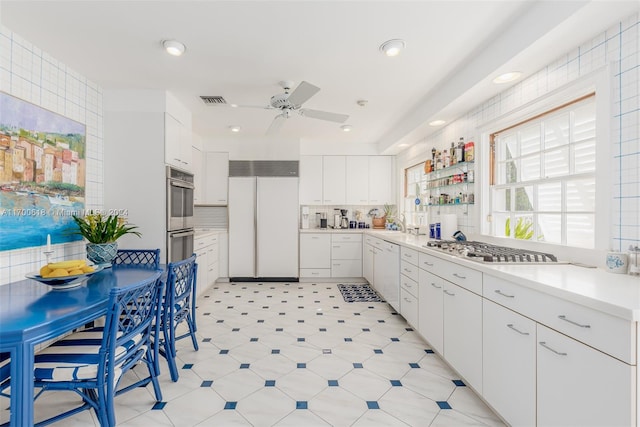 kitchen with backsplash, white cabinetry, ceiling fan, and appliances with stainless steel finishes