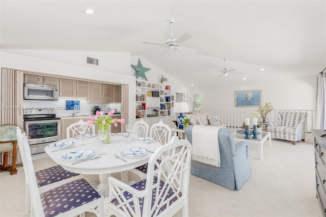 carpeted dining area with vaulted ceiling and ceiling fan