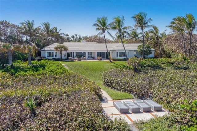 rear view of property with a yard, a patio, and an outdoor hangout area