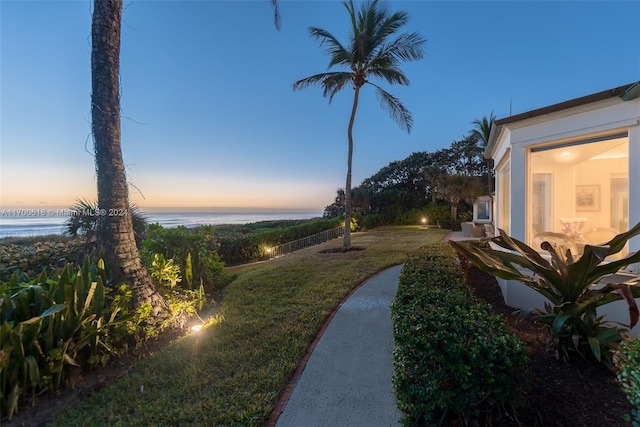 yard at dusk with a water view