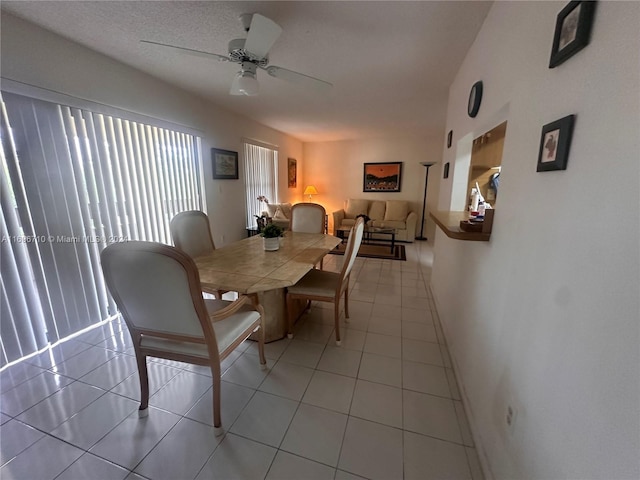 tiled dining area with ceiling fan