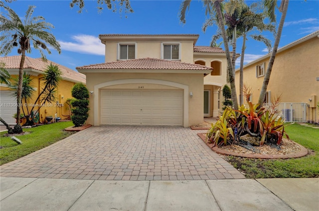 mediterranean / spanish home featuring a front lawn and a garage