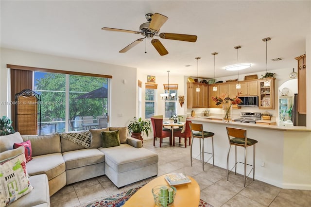 tiled living room featuring ceiling fan