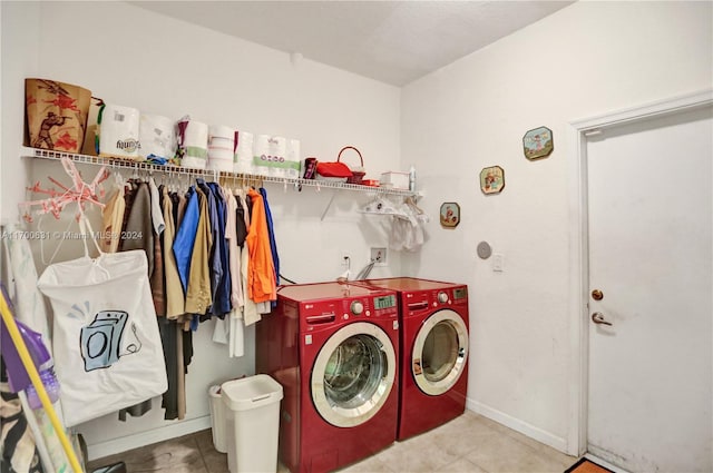 clothes washing area featuring washer and dryer and light tile patterned floors