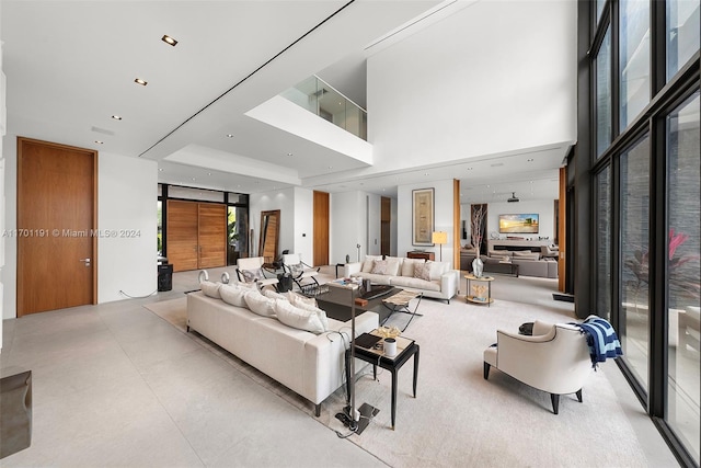 living room featuring a high ceiling and floor to ceiling windows