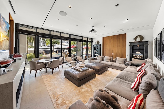 living room featuring a wall of windows and light tile patterned flooring