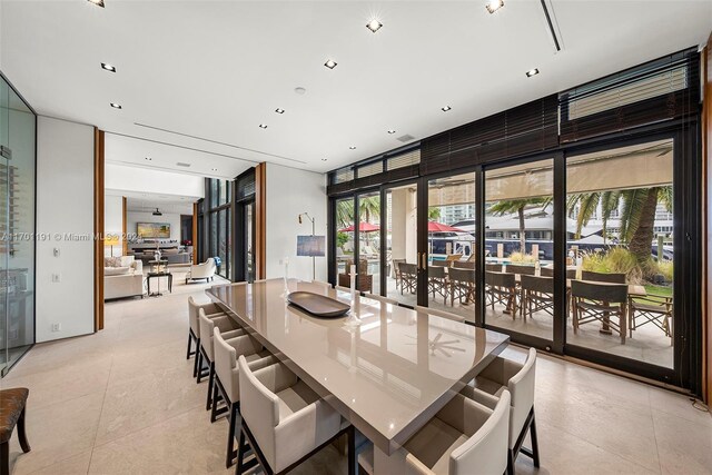 dining space with light tile patterned flooring and a healthy amount of sunlight