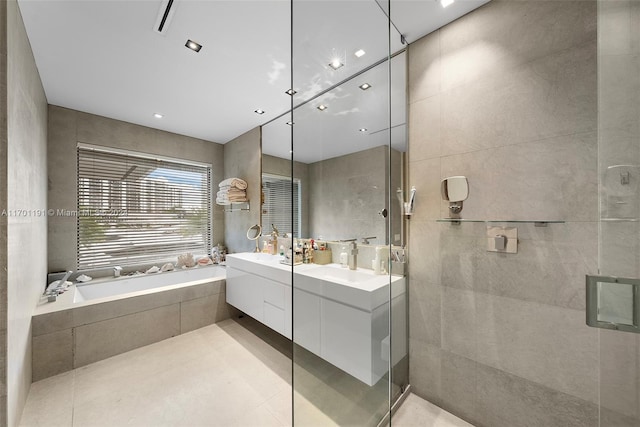 bathroom featuring tile patterned flooring, vanity, tile walls, and independent shower and bath