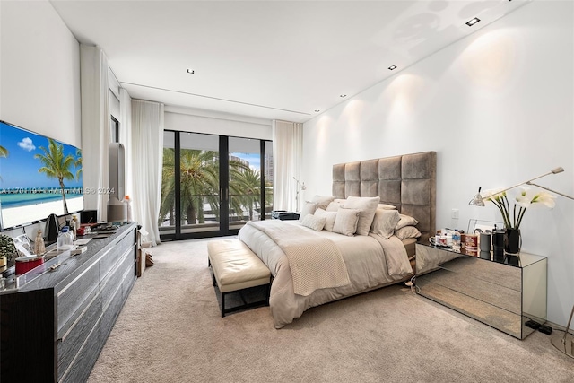 bedroom featuring access to exterior and light colored carpet