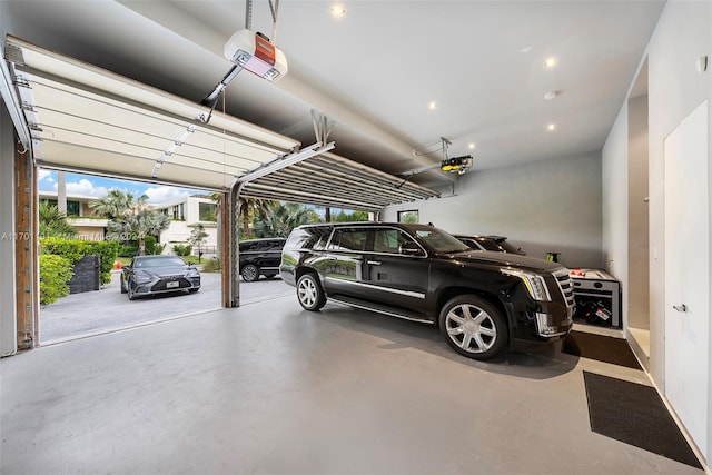 garage featuring a garage door opener and a carport