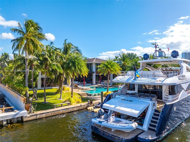 view of dock featuring a yard and a water view