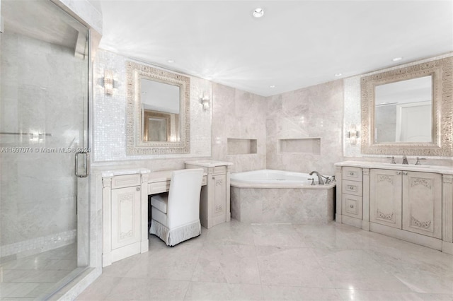 bathroom with vanity, separate shower and tub, and tile walls