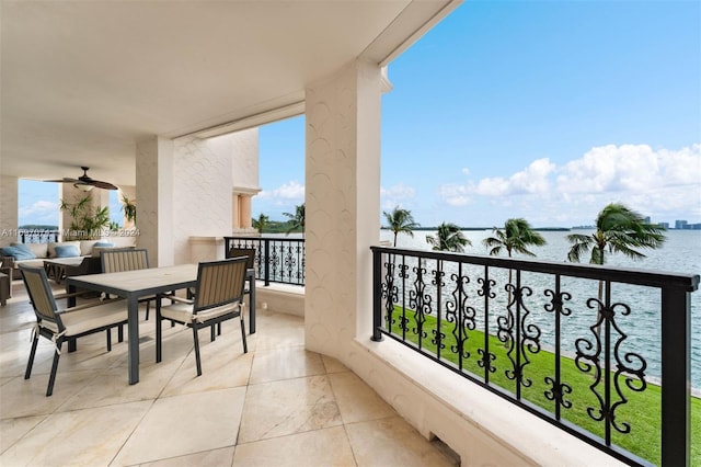 balcony featuring ceiling fan and a water view