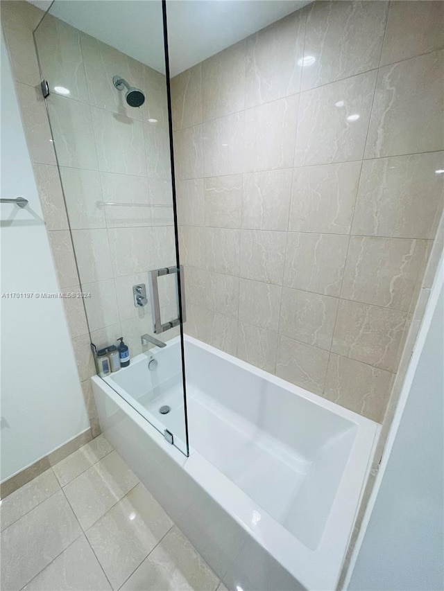 bathroom featuring tile patterned flooring and tiled shower / bath