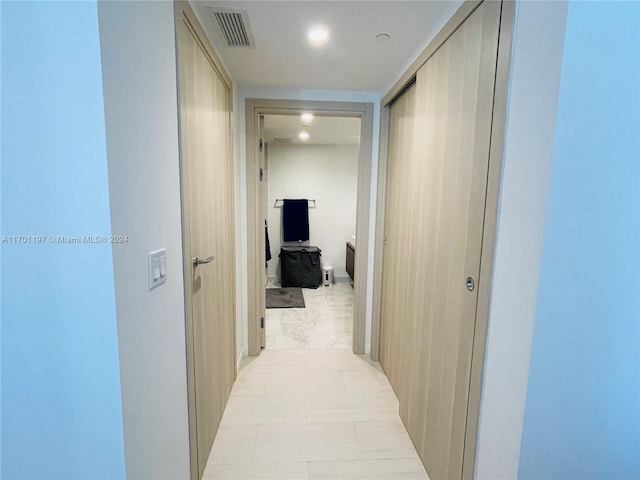 corridor with light tile patterned flooring