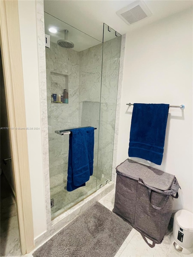 bathroom with a tile shower