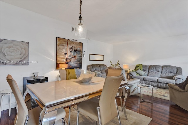 dining space featuring dark wood-type flooring