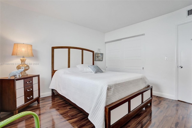 bedroom with a closet and dark wood-type flooring