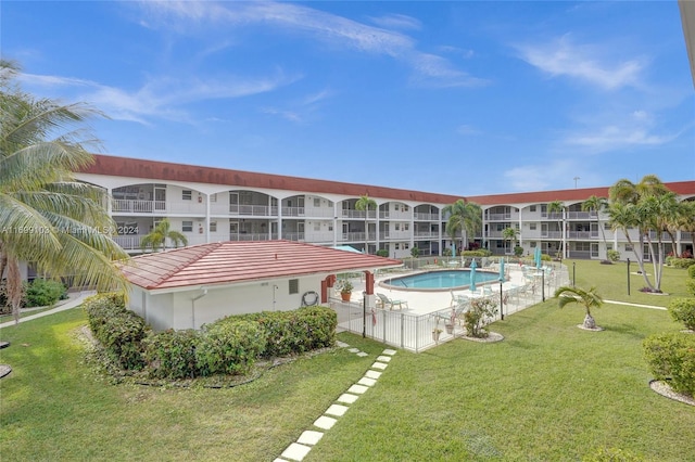 view of pool with a lawn