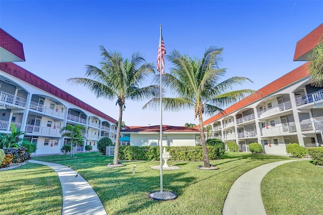 view of property's community with a lawn