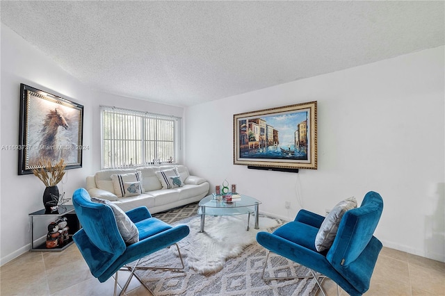 living room featuring light tile patterned flooring and a textured ceiling