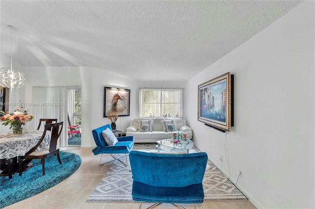 tiled living room featuring a textured ceiling