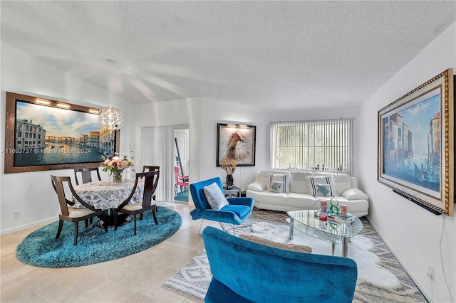 tiled living room with vaulted ceiling, a textured ceiling, and a chandelier