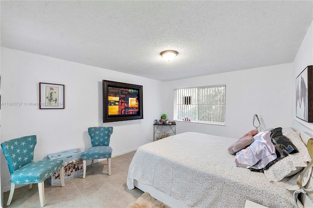 tiled bedroom with a textured ceiling