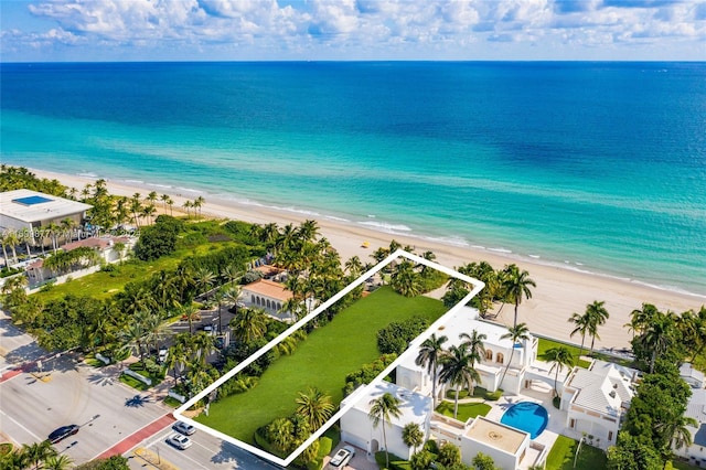 drone / aerial view featuring a water view and a view of the beach