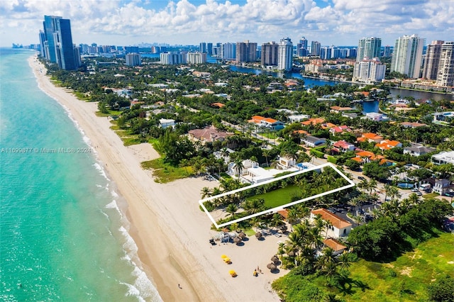 birds eye view of property with a view of the beach and a water view