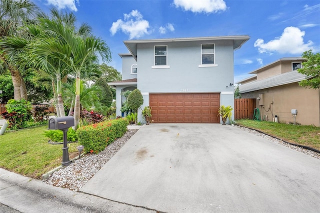 view of front property with a garage and a front yard