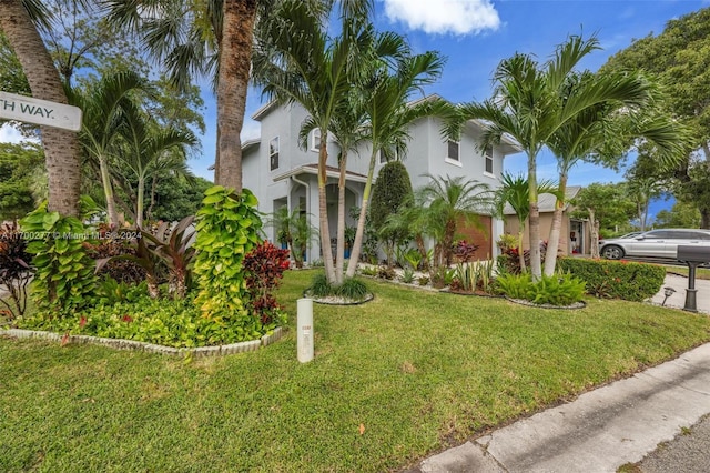 mediterranean / spanish home featuring a front lawn