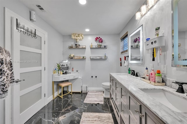 bathroom featuring vanity and toilet