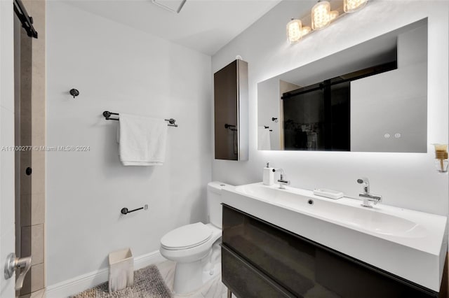 bathroom featuring toilet, vanity, and walk in shower