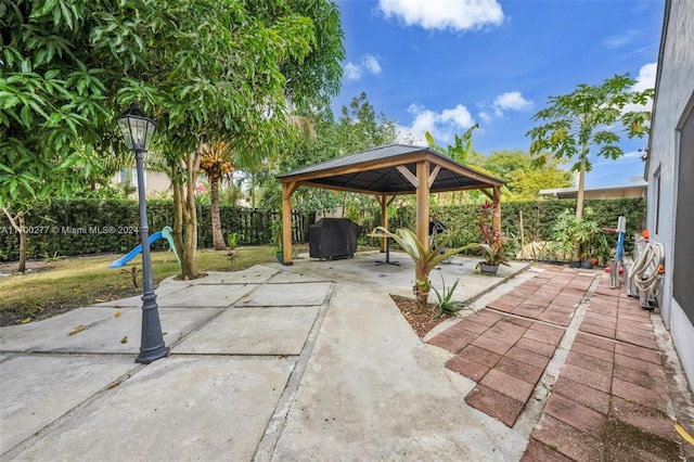 view of patio featuring a gazebo and a grill