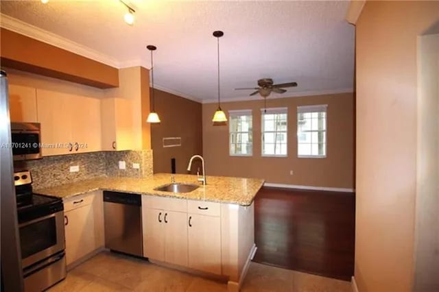 kitchen with kitchen peninsula, light stone countertops, stainless steel appliances, ceiling fan, and sink