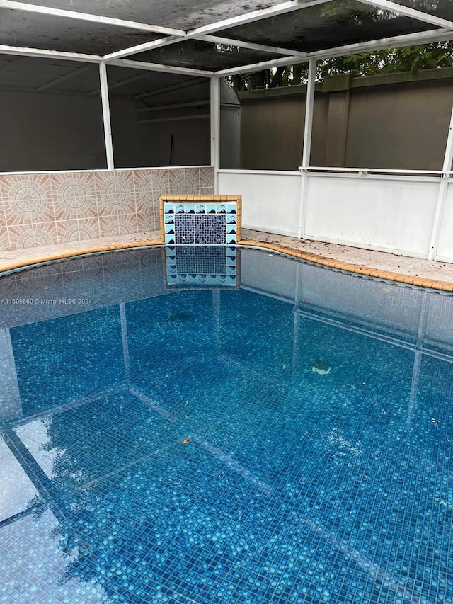 view of pool featuring a lanai