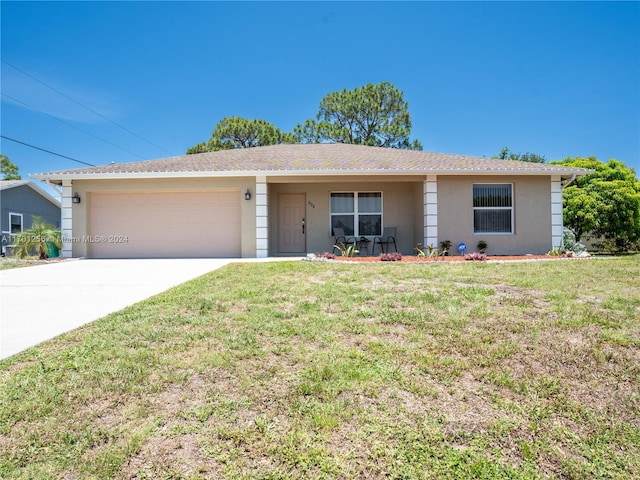 ranch-style home with a garage and a front lawn