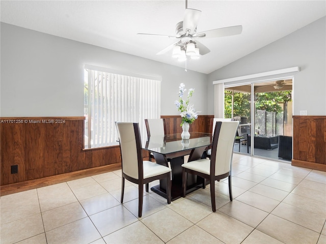 tiled dining room with ceiling fan and lofted ceiling