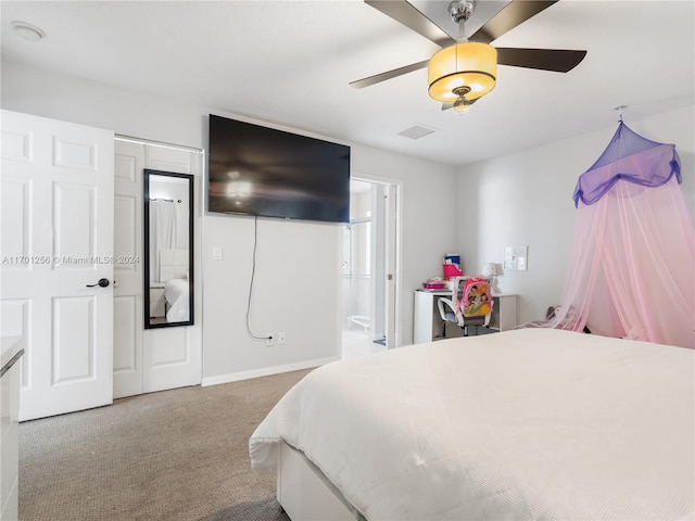 carpeted bedroom with ceiling fan and ensuite bathroom