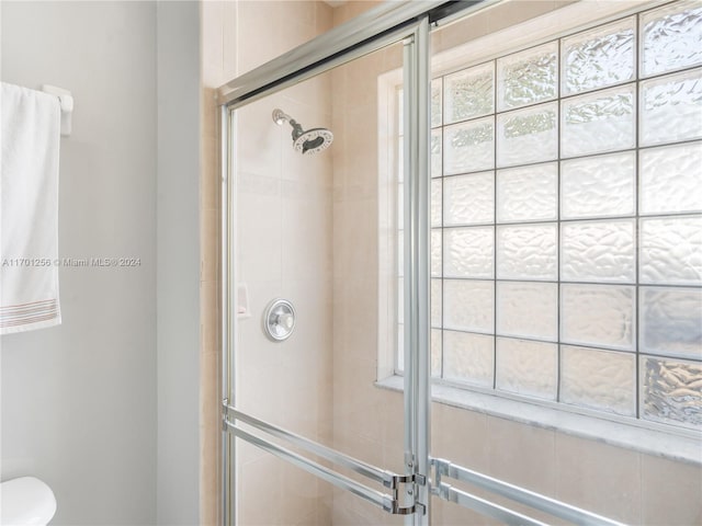 bathroom with a shower with shower door