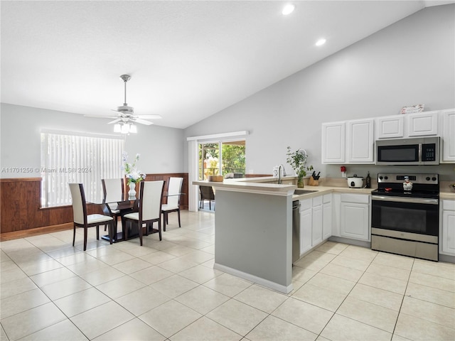 kitchen with kitchen peninsula, appliances with stainless steel finishes, white cabinetry, and ceiling fan